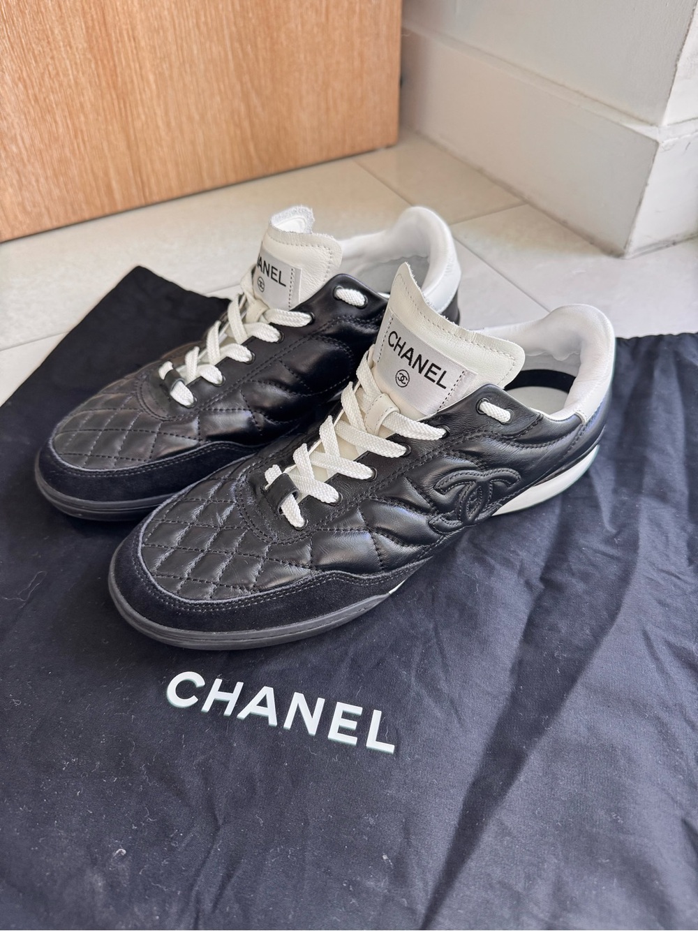 CHANEL Black Quilted Leather Women’s Sneakers with White Accents